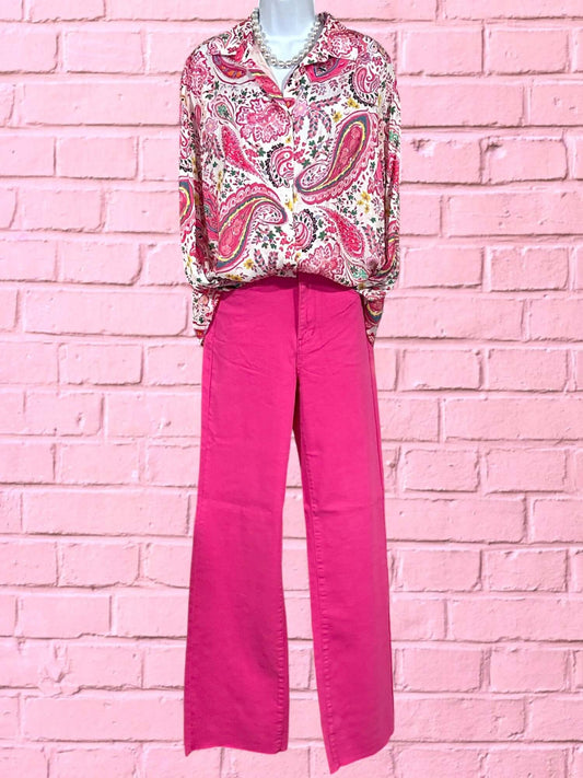 Pink Jeans on hanging mannequin wearing a paisley top